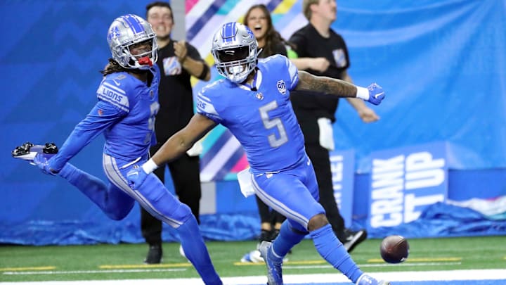 Lions receiver Jameson Williams celebrates with running back David Montgomery (5)