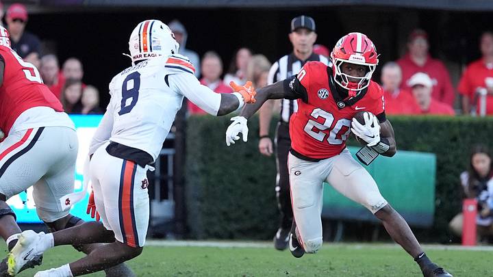 Oct 17, 2026; Athens, Georgia, USA; Georgia running back Dwight Phillips Jr. (20) runs for a gain past Auburn defensive back Kaleb Harris (8) during the third quarter at Sanford Stadium. Mandatory Credit: Dale Zanine-Imagn Images Oct 17, 2026; Athens, Georgia, USA; Georgia running back Dwight Phillips Jr. (20) runs for a gain past Auburn defensive back Kaleb Harris (8) during the third quarter at Sanford Stadium. Mandatory Credit: Dale Zanine-Imagn Images