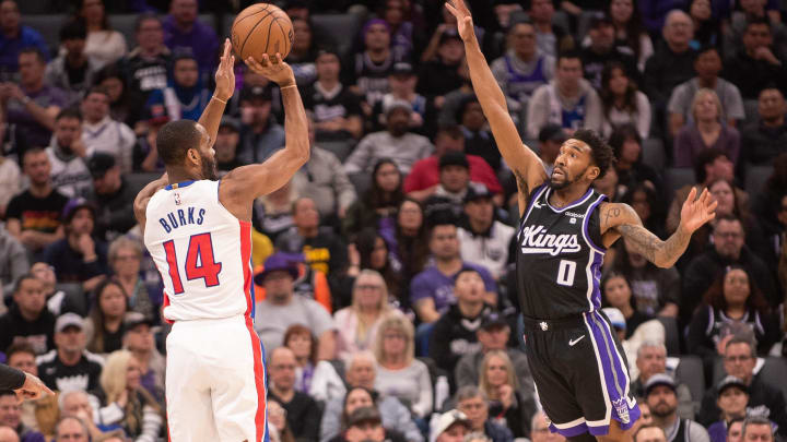 Feb 7, 2024; Sacramento, California, USA; Detroit Pistons guard Alec Burks (14) takes a shot over Sacramento Kings guard Malik Monk (0).