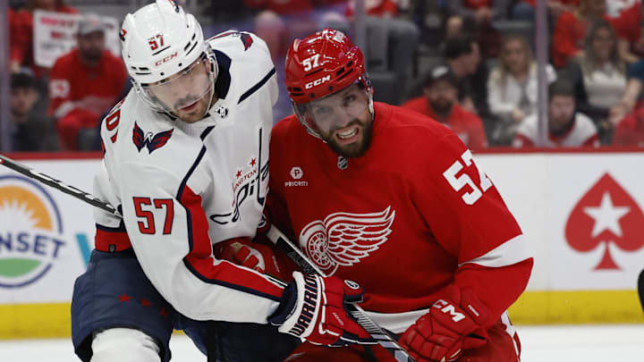 Apr 9, 2024; Detroit, Michigan, USA;  Washington Capitals defenseman Trevor van Riemsdyk (57) and Detroit Red Wings left wing David Perron (57) fight for position in the second period at Little Caesars Arena. Mandatory Credit: Rick Osentoski-Imagn Images