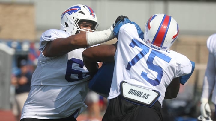 Bills O'Cyrus Torrence pushes at Richard Gouraige during practice at Bills training camp.