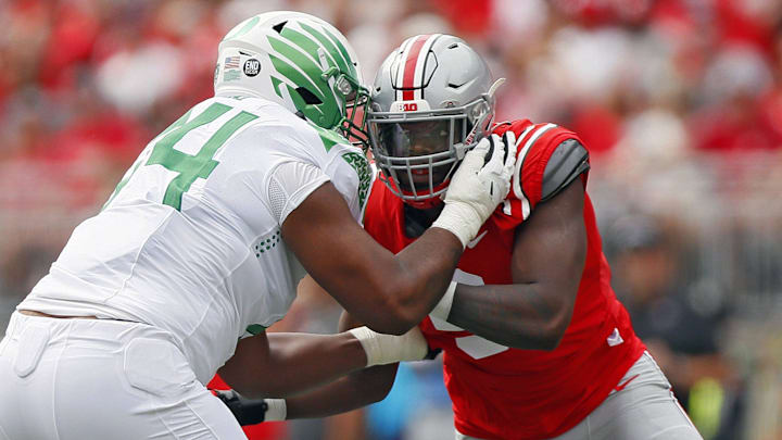 Ohio State Buckeyes defensive end Zach Harrison (9) goes up against Oregon Ducks offensive lineman Steven Jones (74)