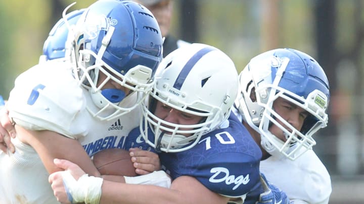 Rockland High School's Liam Wallace tackles Cumberland, Rhode Island, High School's Miguel Garcia in the backfield for a loss on Sunday,  Sept. 12, 2021.