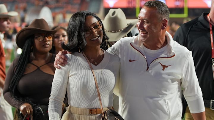exas Longhorns head coach Steve Sarkisian and his wife Loreal Sarkisian walk off the field after defeating the Kentucky Wildcats. exas Longhorns head coach Steve Sarkisian and his wife Loreal Sarkisian walk off the field after defeating the Kentucky Wildcats.
