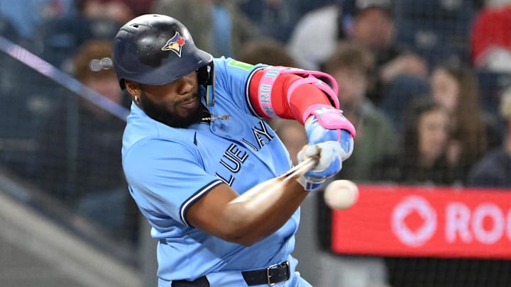 Apr 20, 2025; Toronto, Ontario, CAN;  Toronto Blue Jays first baseman Vladimir Guerrero Jr. (27) hits a single against the Seattle Mariners in the fourth inning at Rogers Centre. 