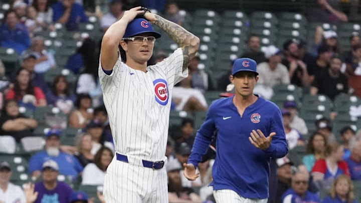 Sep 22, 2024; Chicago, Illinois, USA; Chicago Cubs pitcher Ethan Roberts (39) and manager Craig Counsell (30) argue a call against the Washington Nationals during the eighth inning at Wrigley Field.