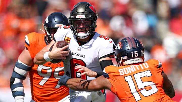 Sep 22, 2024; Tampa, Florida, USA; Tampa Bay Buccaneers quarterback Baker Mayfield (6) tries to avoid a tackle by Denver Broncos linebacker Nik Bonitto (15) in the fourth quarter at Raymond James Stadium. Sep 22, 2024; Tampa, Florida, USA; Tampa Bay Buccaneers quarterback Baker Mayfield (6) tries to avoid a tackle by Denver Broncos linebacker Nik Bonitto (15) in the fourth quarter at Raymond James Stadium.