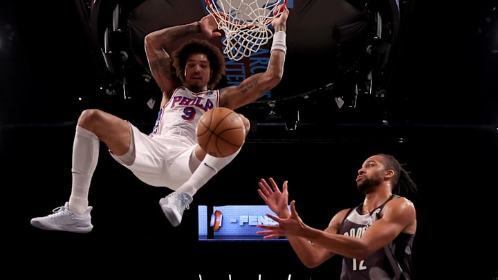 Philadelphia 76ers guard Kelly Oubre Jr. hangs on the rim after a dunk against Brooklyn Nets forward Tosan Evbuomwan. Philadelphia 76ers guard Kelly Oubre Jr. hangs on the rim after a dunk against Brooklyn Nets forward Tosan Evbuomwan.