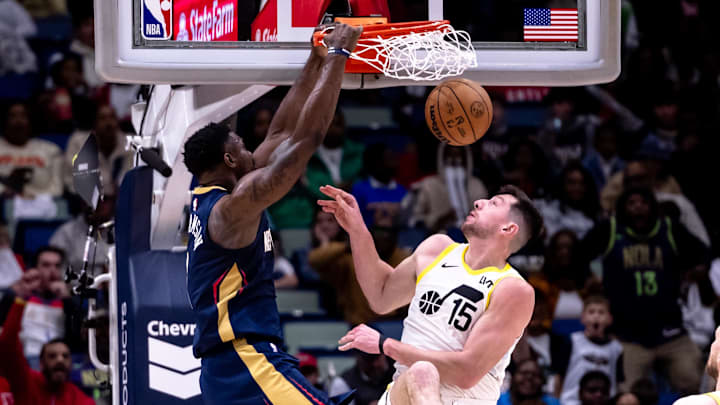 Jan 17, 2025; New Orleans, Louisiana, USA; New Orleans Pelicans forward Zion Williamson (1) dunks the ball through the arm of Utah Jazz forward Drew Eubanks (15) during the second half at Smoothie King Center. Mandatory Credit: Stephen Lew-Imagn Images