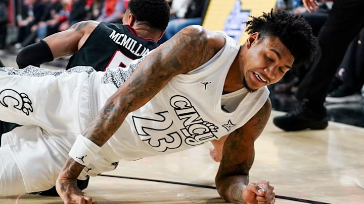 Cincinnati Bearcats forward Dillon Mitchell (23) and Texas Tech Red Raiders guard Chance McMillian (0) fall in the second half of a NCAA men’s basketball game between the Cincinnati Bearcats and Texas Tech Red Raiders, Tuesday, Jan. 21, 2025, at Fifth Third Arena in Cincinnati. Red Raiders won 81-71.