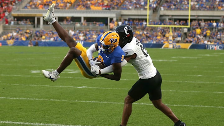 Pittsburgh Panthers Konata Mumpfield (9) hauls in a pass for a touchdown while being covered by Cincinnati Bearcats Taj Ward (15) during the first half at Acrisure Stadium in Pittsburgh, PA on September 9, 2023