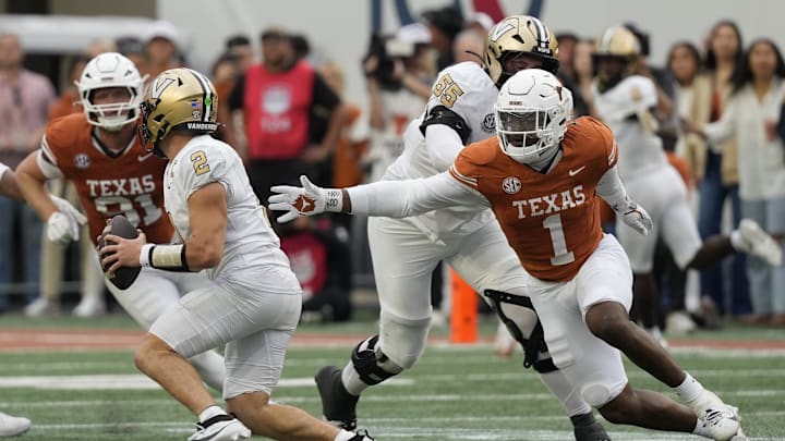 Nov 1, 2025; Austin, Texas, USA; Texas Longhorns defensive lineman Colin Simmons (1) reaches for Vanderbilt Commodores quarterback Diego Pavia (2) during the second half Darrell K Royal-Texas Memorial Stadium. Mandatory Credit: Scott Wachter-Imagn Images