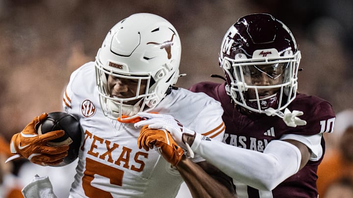 Texas Longhorns wide receiver Ryan Wingo carries the ball against Texas A&M Aggies defensive back Dezz Ricks in the second quarter of the Lone Star Showdown game at Kyle Field.