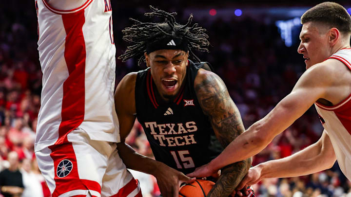 Feb 14, 2026; Tucson, Arizona, USA; Arizona Wildcats forward Ivan Kharchenkov (8) attempts to steal the ball from Texas Tech Red Raiders forward JT Toppin (15) during the first half of the game at McKale Memorial Center.