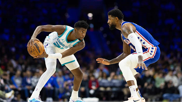 Nov 10, 2024; Philadelphia, Pennsylvania, USA; Charlotte Hornets forward Brandon Miller (24) controls the ball against Philadelphia 76ers forward Paul George (8) during the second quarter at Wells Fargo Center. Mandatory Credit: Bill Streicher-Imagn Images