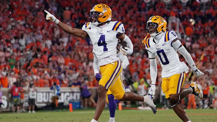 Aug 30, 2025; Clemson, South Carolina, USA; LSU Tigers cornerback Mansoor Delane (4) celebrates with safety Tamarcus Cooley (0) after a play against the Clemson Tigers during the second half at Memorial Stadium. Mandatory Credit: Ken Ruinard-USA TODAY Network via Imagn Images