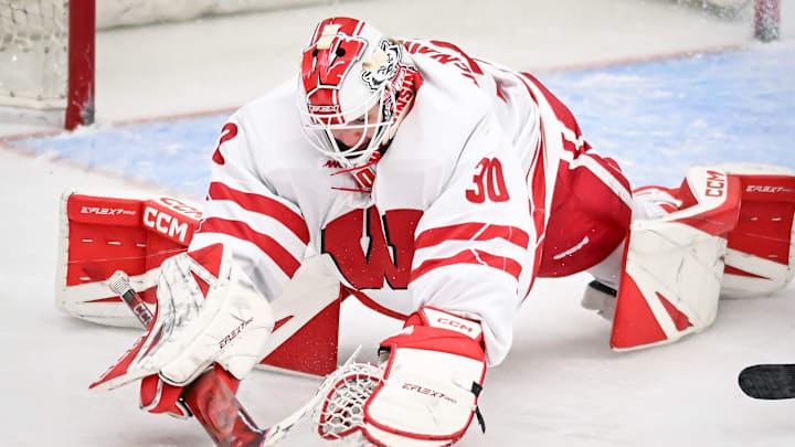 Wisconsin goaltender Ava McNaughton (30) covers the puck against Maine in the second period of a game Friday, October 3, 2025, at LaBahn Arena in Madison, Wisconsin.