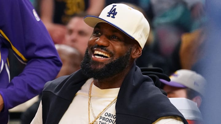 Oct 5, 2025; San Francisco, California, USA; Los Angeles Lakers forward LeBron James (23), wearing a Los Angeles Dodgers hat, smiles after watching his son, guard Bronny James (9), dunk a rebound against the Golden State Warriors in the third quarter at Chase Center. Mandatory Credit: David Gonzales-Imagn Images Oct 5, 2025; San Francisco, California, USA; Los Angeles Lakers forward LeBron James (23), wearing a Los Angeles Dodgers hat, smiles after watching his son, guard Bronny James (9), dunk a rebound against the Golden State Warriors in the third quarter at Chase Center. Mandatory Credit: David Gonzales-Imagn Images