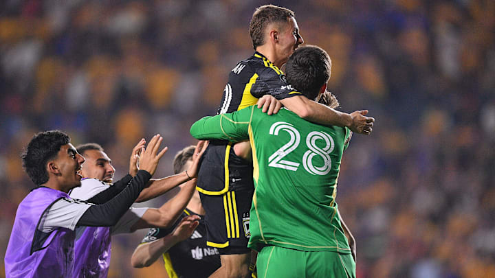 Maximilian Arfsten (top) and goalie Patrick Schulte celebrate after the Columbus Crew defeated Liga MX rival Tigres in a penalty shootout to advance to the Concacaf Champions Cup semifinals.  