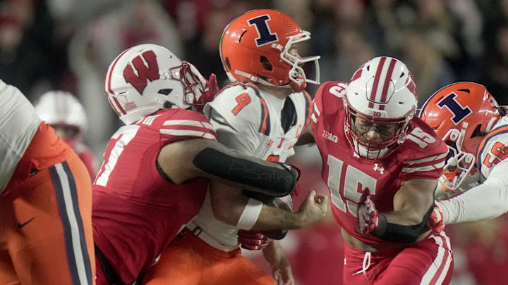 Illinois quarterback Luke Altmyer (9) is sacked by Wisconsin linebacker Darryl Peterson (17) and linebacker Sebastian Cheeks (15) during the first quarter of their game Saturday, November 22, 2025 at Camp Randall Stadium in Madison, Wisconsin.