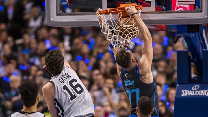 Jan 16, 2019; Dallas, TX, USA; Dallas Mavericks forward Luka Doncic (77) dunks the ball past San Antonio Spurs center Pau Gasol (16) during the second quarter at the American Airlines Center. Mandatory Credit: Jerome Miron-Imagn Images