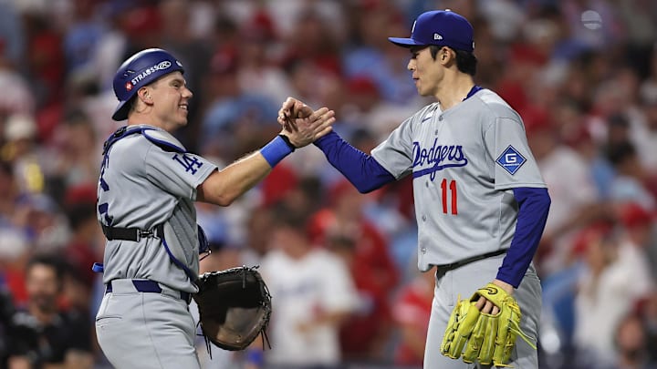 Oct 4, 2025; Philadelphia, Pennsylvania, USA; Los Angeles Dodgers pitcher Roki Sasaki (11) and catcher Will Smith (16) celebrate after defeating the Philadelphia Phillies in  game one of the NLDS round for the 2025 MLB playoffs at Citizens Bank Park. Mandatory Credit: Bill Streicher-Imagn Images