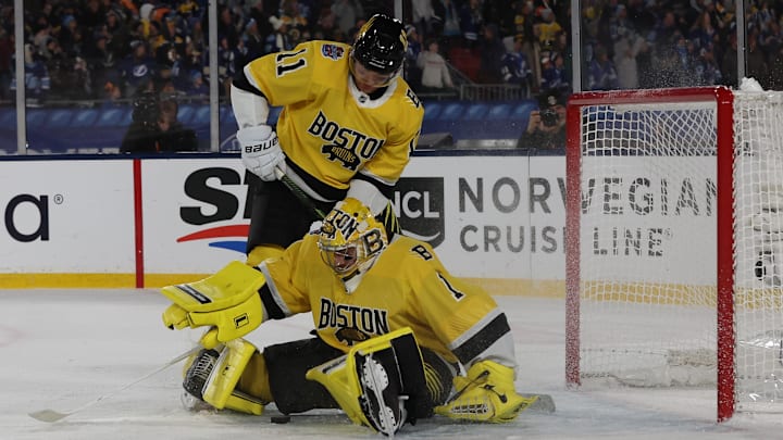 Feb 1, 2026; Tampa Bay, Florida, USA; Boston Bruins goaltender Jeremy Swayman (1) makes the save as center Casey Mittelstadt (11) looks on against the Tampa Bay Lightning during overtime in the 2026 Stadium Series ice hockey game at Raymond James Stadium. Mandatory Credit: Kim Klement Neitzel-Imagn Images