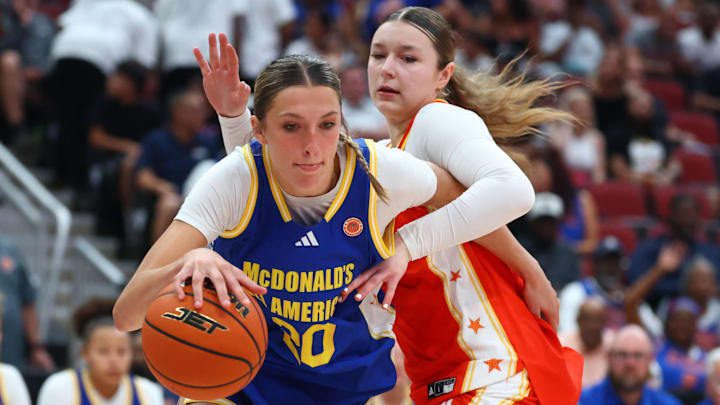 Mar 31, 2026; Glendale, AZ, USA; McKenna Woliczko (20) drives to the basket against Savannah Swords (8) during the McDonalds All American Girls Game at Desert Diamond Arena. Mandatory Credit: Mark J. Rebilas-Imagn Images