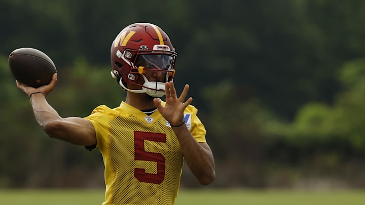Jul 23, 2025; Ashburn, VA, USA; Washington Commanders quarterback Jayden Daniels (5) passes a ball during practice on day one of training camp at OrthoVirginia Training Center at Commanders Park. Mandatory Credit: Geoff Burke-Imagn Images
