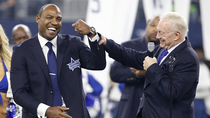 Dallas Cowboys former player Darren Woodson is congratulated by owner Jerry Jones during his induction into the ring of honor at halftime of the game against the Seattle Seahawks.