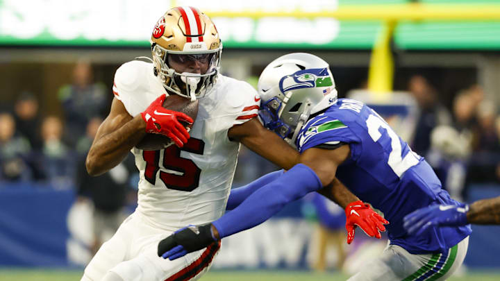 Oct 10, 2024; Seattle, Washington, USA; San Francisco 49ers wide receiver Jauan Jennings (15) runs for yards after the catch against Seattle Seahawks cornerback Tre Brown (22) during the second quarter at Lumen Field. Mandatory Credit: Joe Nicholson-Imagn Images