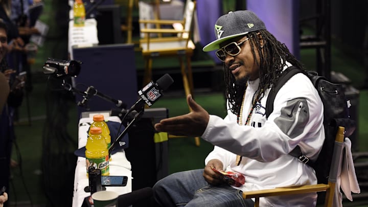 Jan 27, 2015; Phoenix, AZ, USA; Seattle Seahawks running back Marshawn Lynch sits at his podium during media day for Super Bowl XLIX at US Airways Center. Mandatory Credit: Kyle Terada-Imagn Images