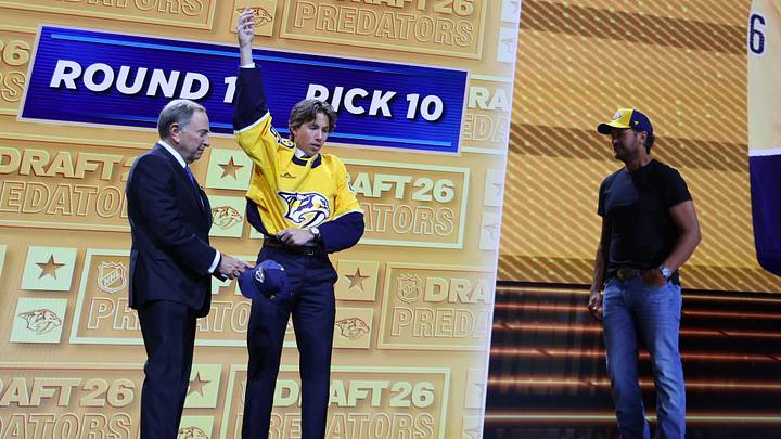 Jun 26, 2026; Buffalo, New York, USA; Wyatt Cullen reacts beside NHL commissioner Gary Bettman and country singer Luke Bryan after being selected with the tenth pick in the first round of the 2026 NHL Draft by the Nashville Predators at KeyBank Center. Mandatory Credit: Timothy T. Ludwig-Imagn Images