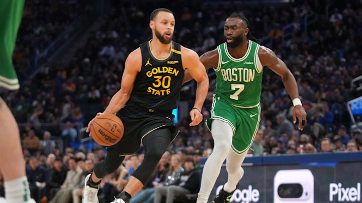 Golden State Warriors guard Stephen Curry dribbles past Boston Celtics forward Jaylen Brown