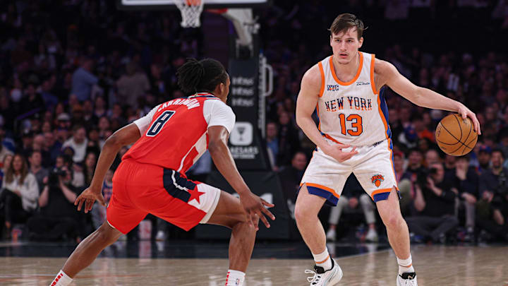Mar 22, 2025; New York, New York, USA; New York Knicks guard Tyler Kolek (13) dribbles as Washington Wizards guard Bub Carrington (8) defends during the first half at Madison Square Garden. Mandatory Credit: Vincent Carchietta-Imagn Images