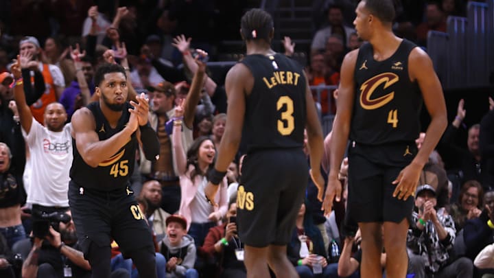 Nov 5, 2023; Cleveland, Ohio, USA; Cleveland Cavaliers guard Donovan Mitchell (45) reacts with teammates guard Caris LeVert (3) and center Evan Mobley (4) during the fourth quarter against the Golden State Warriors at Rocket Mortgage FieldHouse. Mandatory Credit: Aaron Josefczyk-USA TODAY Sports