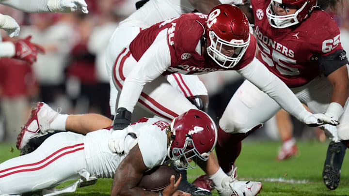 Oklahoma defensive lineman Ethan Downs (40) brings down Alabama quarterback Jalen Milroe (4) during their game at Gaylord Family - Oklahoma Memorial Stadium in Norman, Okla., Saturday, Nov. 23, 2024.