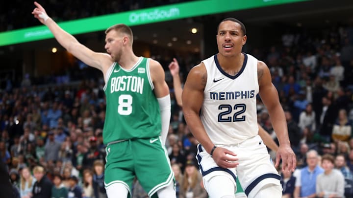 Nov 19, 2023; Memphis, Tennessee, USA; Memphis Grizzlies guard Desmond Bane (22) and Boston Celtics center Kristaps Porzingis (8) react after a turnover during the second half at FedExForum. Mandatory Credit: Petre Thomas-USA TODAY Sports