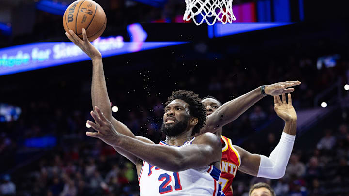 Oct 20, 2023; Philadelphia, Pennsylvania, USA; Philadelphia 76ers center Joel Embiid (21) drives for a shot past Atlanta Hawks forward Onyeka Okongwu (17) during the fourth quarter at Wells Fargo Center. Mandatory Credit: Bill Streicher-Imagn Images Oct 20, 2023; Philadelphia, Pennsylvania, USA; Philadelphia 76ers center Joel Embiid (21) drives for a shot past Atlanta Hawks forward Onyeka Okongwu (17) during the fourth quarter at Wells Fargo Center. Mandatory Credit: Bill Streicher-Imagn Images