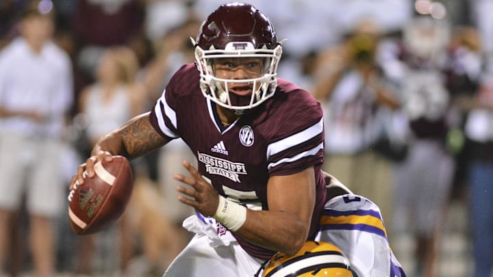 Mississippi State Bulldogs quarterback Dak Prescott (15) is sacked by LSU Tigers defensive end Arden Key (49).