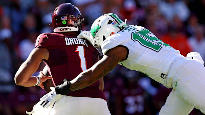 Marshall Thundering Herd defensive lineman Mike Green sacks Virginia Tech Hokies quarterback Kyron Drones.