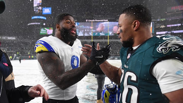 Jan 19, 2025; Philadelphia, Pennsylvania, USA; Los Angeles Rams linebacker Jared Verse (8) greets Philadelphia Eagles running back Saquon Barkley (26) after their 2025 NFC divisional round game at Lincoln Financial Field. Mandatory Credit: Eric Hartline-Imagn Images