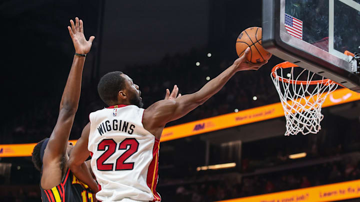 Dec 26, 2025; Atlanta, Georgia, USA; Miami Heat forward Andrew Wiggins (22) jumps for a layup against Atlanta Hawks forward Onyeka Okongwu (17)during the first quarter at State Farm Arena. Mandatory Credit: Jordan Godfree-Imagn Images