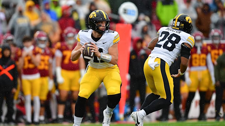 Nov 15, 2025; Los Angeles, California, USA; Iowa Hawkeyes quarterback Mark Gronowski (11) drops back to pass against the Southern California Trojans during the first half at the Los Angeles Memorial Coliseum. Mandatory Credit: Gary A. Vasquez-Imagn Images Nov 15, 2025; Los Angeles, California, USA; Iowa Hawkeyes quarterback Mark Gronowski (11) drops back to pass against the Southern California Trojans during the first half at the Los Angeles Memorial Coliseum. Mandatory Credit: Gary A. Vasquez-Imagn Images