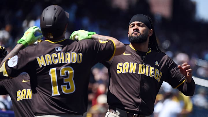 Sep 7, 2025; Denver, Colorado, USA; San Diego Padres third base Manny Machado (13) celebrates with outfielder Fernando Tatis Jr. (23) after a two-run home run during the first inning against the Colorado Rockies at Coors Field. Mandatory Credit: Christopher Hanewinckel-Imagn Images
