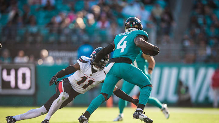 Dec 1, 2024; Jacksonville, Florida, USA; Jacksonville Jaguars running back Tank Bigsby (4) runs the ball against Houston Texans cornerback Jeff Okudah (11) in the third quarter at EverBank Stadium. Mandatory Credit: Jeremy Reper-Imagn Images Dec 1, 2024; Jacksonville, Florida, USA; Jacksonville Jaguars running back Tank Bigsby (4) runs the ball against Houston Texans cornerback Jeff Okudah (11) in the third quarter at EverBank Stadium. Mandatory Credit: Jeremy Reper-Imagn Images