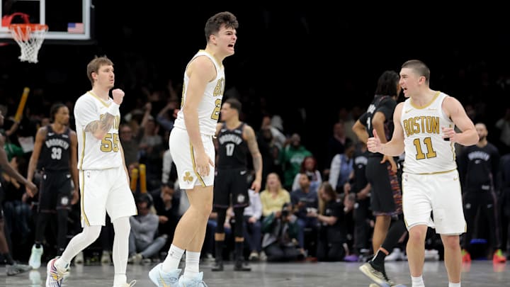Jan 23, 2026; Brooklyn, New York, USA; Boston Celtics guard Hugo Gonzalez (28) celebrates his three point shot against the Brooklyn Nets with guards Baylor Scheierman (55) and Payton Pritchard (11) during the first overtime at Barclays Center. Mandatory Credit: Brad Penner-Imagn Images
