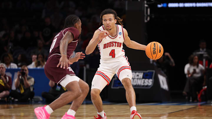 Houston Cougars guard Kingston Flemings (4) drives to the hoop past Texas A&M Aggies guard Marcus Hill (0) during the first half of a second round game of the men's 2026 NCAA Tournament at Paycom Center. 
