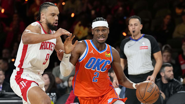 Dec 14, 2024; Las Vegas, Nevada, USA; Oklahoma City Thunder guard Shai Gilgeous-Alexander (2) controls the ball against Houston Rockets forward Dillon Brooks (9) during the first quarter in a semifinal of the 2024 Emirates NBA Cup at T-Mobile Arena. Mandatory Credit: Kyle Terada-Imagn Images Dec 14, 2024; Las Vegas, Nevada, USA; Oklahoma City Thunder guard Shai Gilgeous-Alexander (2) controls the ball against Houston Rockets forward Dillon Brooks (9) during the first quarter in a semifinal of the 2024 Emirates NBA Cup at T-Mobile Arena. Mandatory Credit: Kyle Terada-Imagn Images
