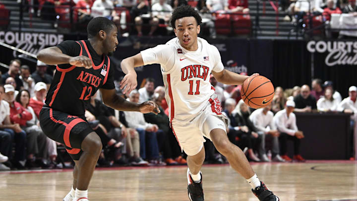 UNLV Rebels guard Dedan Thomas Jr. (11) drives past San Diego State Aztecs guard Darrion Trammell (12) in the first half at Thomas & Mack Center. UNLV Rebels guard Dedan Thomas Jr. (11) drives past San Diego State Aztecs guard Darrion Trammell (12) in the first half at Thomas & Mack Center.